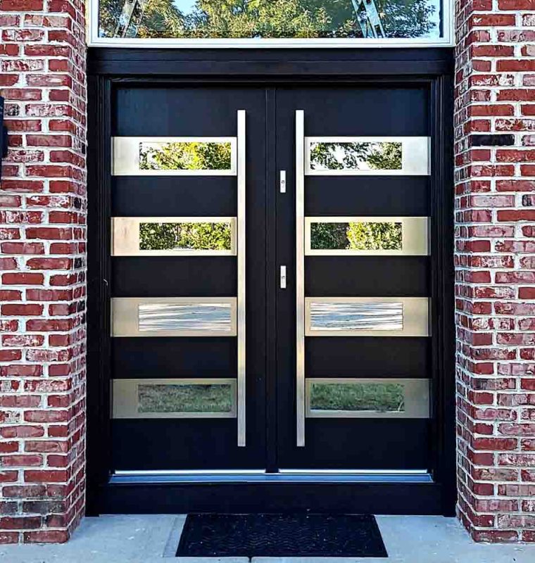 Main door in a double door style with bar handles, glass frame above and reflective glass incorporated