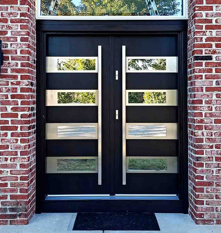 Main door in a double door style with bar handles, glass frame above and reflective glass incorporated