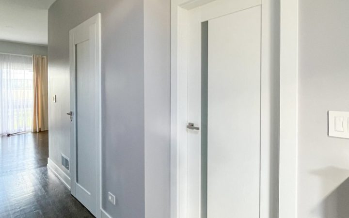 Interior doors painted white to match the interior theme, and with lever handles