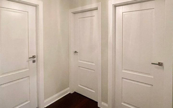Interior doors for each rooms in a house, all with lever handles, and one with a lockset