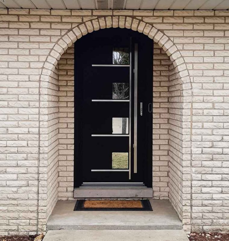 Main door of a house in an arched doorway