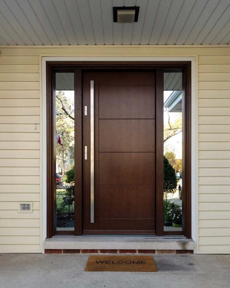 Wood main front door with double lock safety installed and a metal bar handle